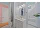 Bathroom featuring a white vanity, artwork, a mirror, and a view of the bathtub and closet at 7507 Ascot Ct, University Park, FL 34201