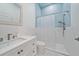 Bathroom with a blue tiled shower, neutral colors, and sleek fixtures and finishes at 7507 Ascot Ct, University Park, FL 34201