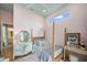 Serene bedroom featuring natural light, a four poster bed, and stylish furnishings at 7507 Ascot Ct, University Park, FL 34201