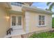 Beige home exterior featuring a double door entry with white trim and manicured landscaping at 7507 Ascot Ct, Bradenton, FL 34201
