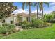 Beautifully landscaped front yard with mature trees complementing a charming home exterior at 7507 Ascot Ct, University Park, FL 34201