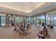 Well-equipped gym with modern exercise machines and expansive windows offering a view of the outdoors at 7507 Ascot Ct, University Park, FL 34201