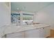 Bright kitchen showcasing white cabinets and beautiful marble countertops that overlook the outdoor pool at 7507 Ascot Ct, Bradenton, FL 34201