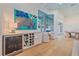 Bright living area with a beverage center, wine rack, modern art, and hardwood floors at 7507 Ascot Ct, Bradenton, FL 34201