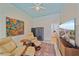 Comfortable living room featuring a ceiling fan, modern art, and relaxed seating with ottoman at 7507 Ascot Ct, University Park, FL 34201