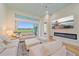 Bright, open-concept living room with views of the backyard and a modern fireplace at 7507 Ascot Ct, Bradenton, FL 34201
