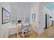 Bright office space featuring a desk, comfortable chair, and natural light from three windows with wood flooring at 7507 Ascot Ct, Bradenton, FL 34201