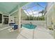 Relaxing screened pool with a swing, surrounded by ample seating and lush tropical greenery at 7507 Ascot Ct, University Park, FL 34201