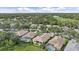 Aerial view of beautiful homes with screened pools, lush landscaping, and a serene lake at 7507 Ascot Ct, University Park, FL 34201