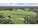 Expansive aerial view of golf course featuring lush greenery, water hazards, and manicured greens at 7507 Ascot Ct, University Park, FL 34201