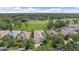 Overhead view of homes with screened lanais, lush landscaping, and golf course in the distance at 7507 Ascot Ct, University Park, FL 34201