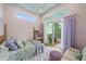Cozy bedroom with access to an outdoor patio with serene views at 7507 Ascot Ct, University Park, FL 34201
