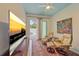 Relaxing bonus room with a large TV, comfortable chairs, and outdoor patio access at 7507 Ascot Ct, University Park, FL 34201