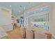 Elegant dining room adjacent to kitchen, with light-colored chairs and view of screened pool at 7507 Ascot Ct, University Park, FL 34201