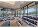 Modern fitness center boasts an array of equipment and large windows offering scenic views at 7507 Ascot Ct, University Park, FL 34201