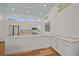 Modern kitchen with light wood floors, white cabinets and marble countertops at 7507 Ascot Ct, University Park, FL 34201