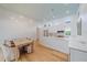 Open kitchen and dining area featuring an island and light wood flooring at 7507 Ascot Ct, University Park, FL 34201