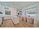 Bright, open kitchen with an island and an adjacent dining area leading to the pool at 7507 Ascot Ct, University Park, FL 34201