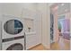 Convenient laundry room with modern washer and dryer, plus built-in storage at 7507 Ascot Ct, University Park, FL 34201