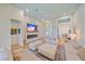 Open-concept living room with a sleek fireplace, large TV, and comfortable seating, perfect for modern living at 7507 Ascot Ct, University Park, FL 34201