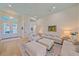 Bright living room with high ceilings, neutral decor, hardwood floors, and French doors, creating a spacious feel at 7507 Ascot Ct, University Park, FL 34201