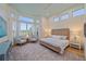 Bright main bedroom with large windows, sitting area, and a serene view of the outside at 7507 Ascot Ct, University Park, FL 34201