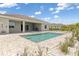 Backyard with an in-ground swimming pool with a sun shelf, and a covered patio with an outdoor kitchen at 7508 Ripetta St, Sarasota, FL 34240