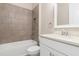 Bathroom featuring shower/tub combination with marble surround, toilet, and vanity with marble countertop at 7508 Ripetta St, Sarasota, FL 34240