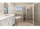 Bright bathroom featuring a glass shower, soaking tub, and double vanity with a neutral color palette at 7508 Ripetta St, Sarasota, FL 34240