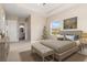 Serene bedroom with a tray ceiling, a painting, and a view into the ensuite bathroom at 7508 Ripetta St, Sarasota, FL 34240