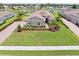 Beautiful home with a tile roof, meticulously maintained lawn, and mature tropical landscaping at 7508 Ripetta St, Sarasota, FL 34240