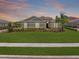 Charming home featuring a lush green lawn, well-manicured landscaping, and a tile roof at 7508 Ripetta St, Sarasota, FL 34240