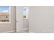 Light filled hallway shows neutral paint, baseboards, and views of the outside through two windows at 7508 Ripetta St, Sarasota, FL 34240