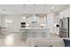 Bright kitchen features a large island, white cabinetry, modern appliances, and pendant lighting at 7508 Ripetta St, Sarasota, FL 34240