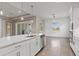 Open-concept living area with tile floors, white cabinets, stainless appliances, and plenty of natural light at 7508 Ripetta St, Sarasota, FL 34240