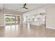 Expansive living area features tile flooring, recessed lighting, and sliding doors to the backyard at 7508 Ripetta St, Sarasota, FL 34240