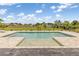 In-ground pool and fenced in backyard featuring a serene backyard escape with green lawn, palm trees, and landscaping at 7508 Ripetta St, Sarasota, FL 34240