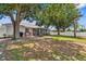 A well maintained backyard with a screened-in porch and mature trees at 8638 Bessemer Ave, North Port, FL 34287