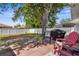 Spacious backyard with shade trees, barbecue grill and privacy fence at 8638 Bessemer Ave, North Port, FL 34287