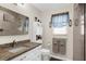 Bathroom with granite counters, tiled shower, and decorative fixtures at 8638 Bessemer Ave, North Port, FL 34287