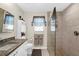 Bathroom featuring granite countertops, new tiling, and a tiled glass shower at 8638 Bessemer Ave, North Port, FL 34287