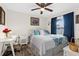 Bright bedroom with a white wicker bed, desk, and blue curtains at 8638 Bessemer Ave, North Port, FL 34287
