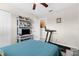 A well-lit bedroom with a ceiling fan, TV, treadmill, and a closet at 8638 Bessemer Ave, North Port, FL 34287