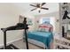 Bedroom with a blue comforter, white furniture, and natural lighting at 8638 Bessemer Ave, North Port, FL 34287