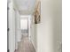 Hallway with wood-look tile flooring leading to an open bathroom at 8638 Bessemer Ave, North Port, FL 34287