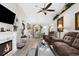 Spacious living room with a fireplace, hardwood floors, and plenty of natural light at 8638 Bessemer Ave, North Port, FL 34287