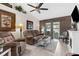 Comfortable living room featuring hardwood floors, a ceiling fan, and a cozy seating area at 8638 Bessemer Ave, North Port, FL 34287