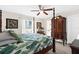 Bright main bedroom featuring a four-poster bed, hardwood floors, and ample natural light at 8638 Bessemer Ave, North Port, FL 34287