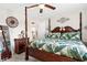 Spacious main bedroom with a four-poster bed, wood furniture, and ceiling fan at 8638 Bessemer Ave, North Port, FL 34287