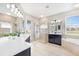 Bright bathroom with double vanity sinks, glass shower and soaking tub with natural light at 8640 Stone Harbour Loop, Bradenton, FL 34212